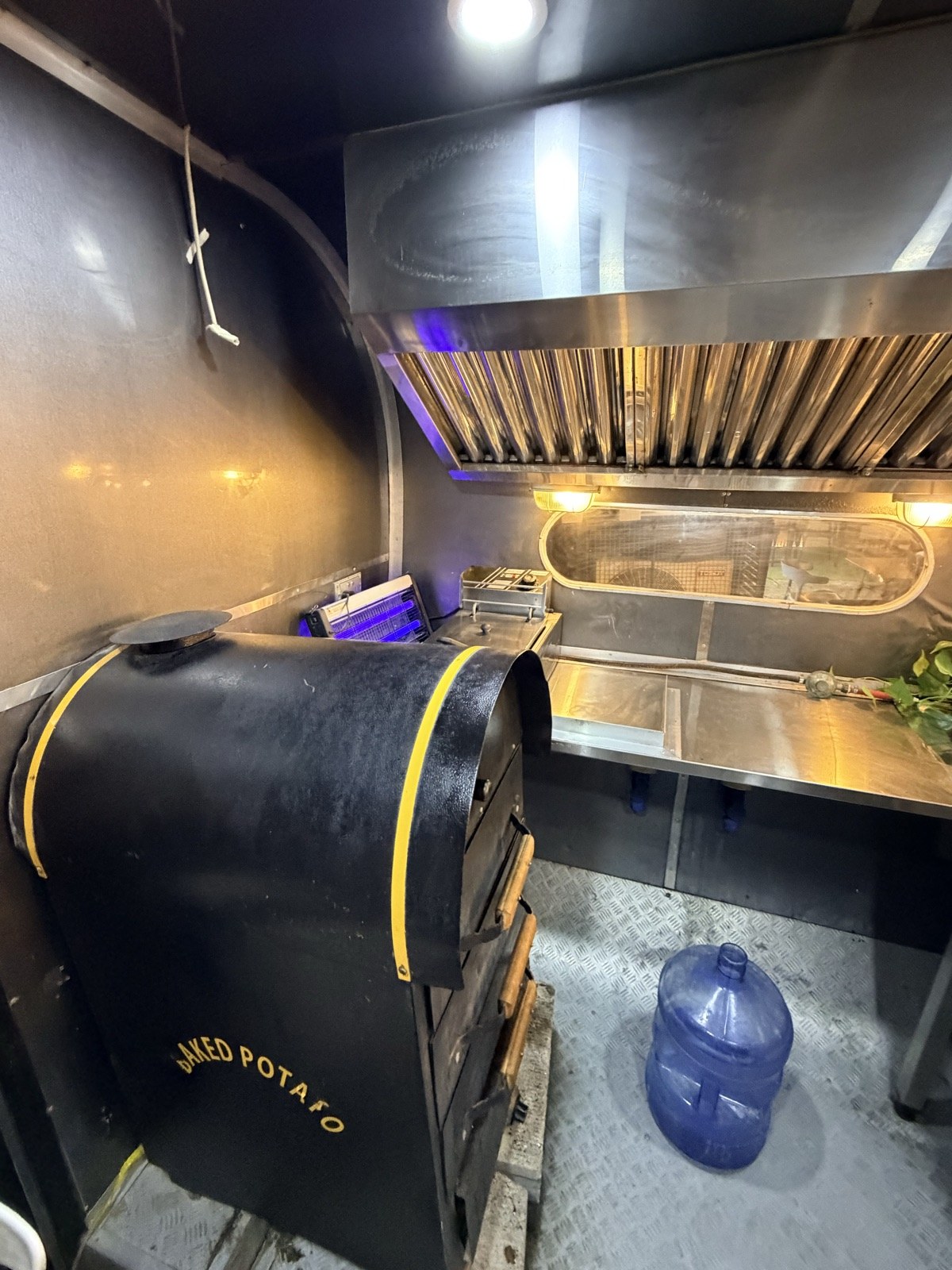The Spudlicious barrel oven where potatoes are baked, inside the truck kitchen