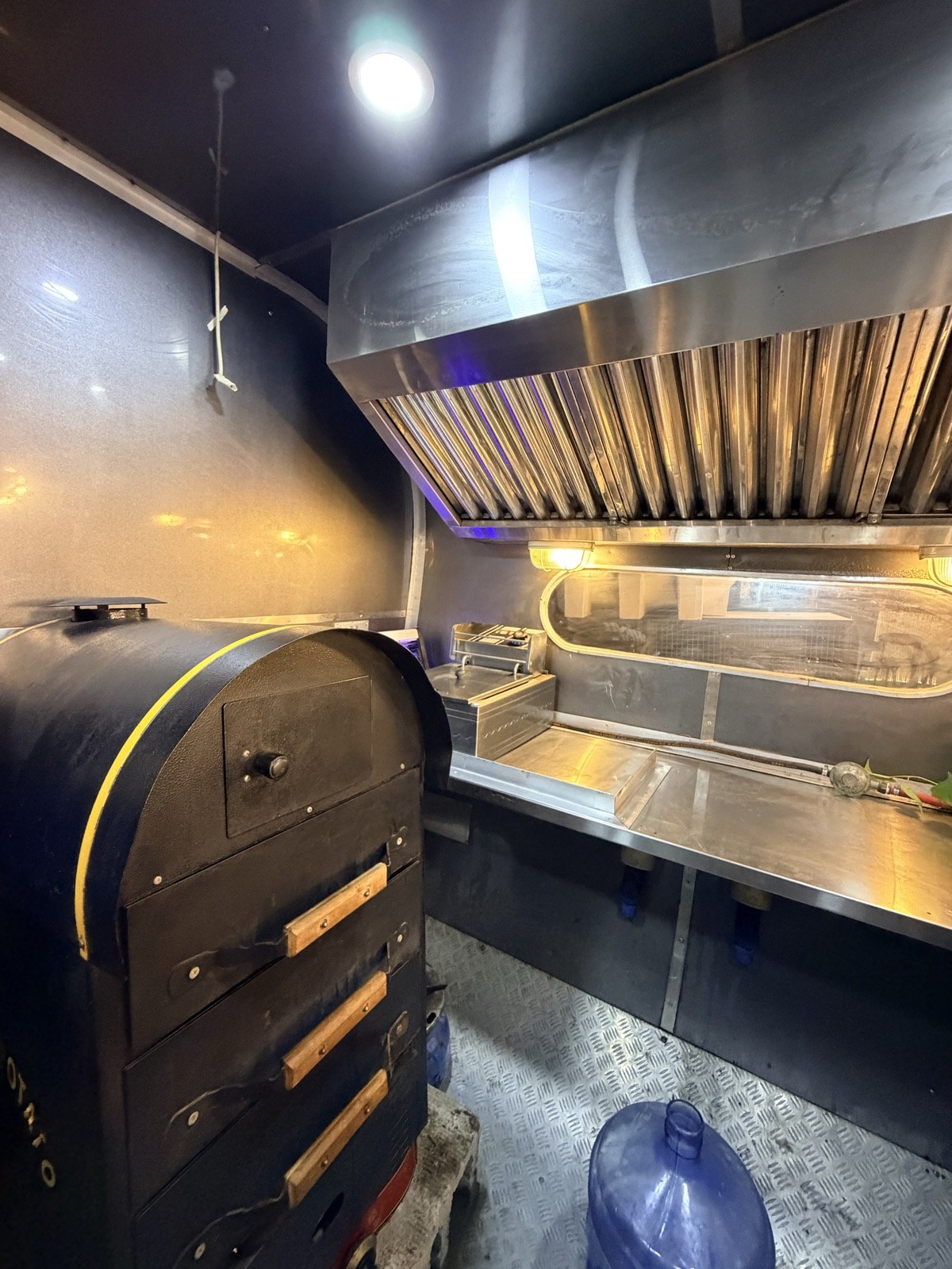 The extraction hood and cooking station inside the Spudlicious truck